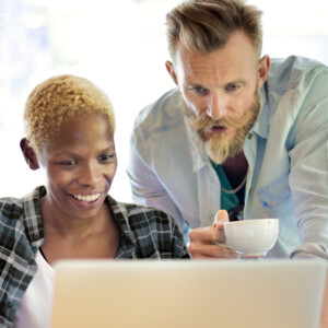 Co-workers looking at computer together