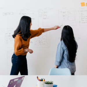 Two women discussing a plan
