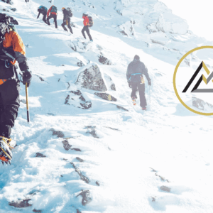 Hikers climbing a snow covered mountain side