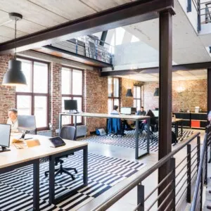 Man walking down stairs in industrial looking office space